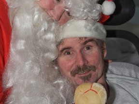 Leona Smith, aka Santa, with her 48-year-old son Wayne at Bridgepoint hospital on Broadview Ave. in Toronto on Christmas Day. (DAVE THOMAS/Toronto Sun)