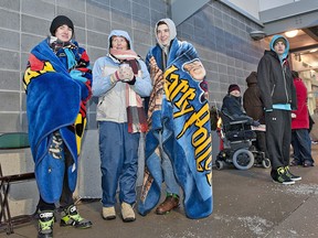 Chris Milmine (left), his mother Pat Foley and brother Spencer Milmine are bundled up against the cold Wednesday morning, December 26, 2012 after arriving at Future Shop on Lynden Road in Brantford to get some Boxing Day deals.  A municipal bylaw in Brantford orders that retail stores not conduct sales until 9 a.m. on Boxing Day.BRIAN THOMPSON/BRANTFORD EXPOSITOR/QMI Agency