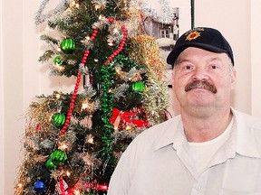 Ed Legocki, chairman of the Good Samaritan Inn in South Porcupine, stands beside the homeless shelter’s Christmas tree, part of his efforts to provide a ray of sunshine into an otherwise painful time of year for many of the residents.