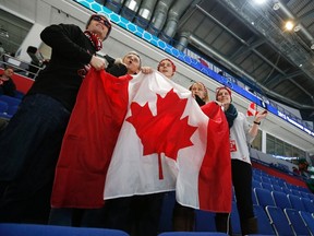 Fans of Canada hold a Canadian national flag before Canada plays Germany in their preliminary round game during the 2013 IIHF U20 World Junior Hockey Championship in Ufa, December 26, 2012. (REUTERS/Mark Blinch)