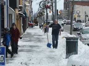 Downtown merchants in Woodstock dug out in front of their businesses after a winter storm that brought snow and high winds during the evening and night of Boxing Day, 2012.