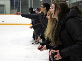 St. Francis Xavier students participate in the puck toss during the first intermission of the 12th annual Chix with Stix fundraiser game.
DALE BOYD Special to the Examiner