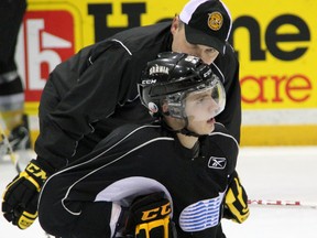 Sarnia Sting assistant coach Alex Galchenyuk Sr., back, gives some advice to his son, Alex Galchenyuk during practice at the RBC Centre in Sarnia, Ont. on Wednesday, Dec. 12, 2012. (PAUL OWEN, The Observer)
