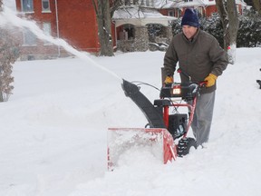 Mervin Coleman of West Lorne handles a snowblower while clearing out his driveway on Graham Road following a Boxing Day snowfall.
