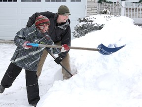 Michael Lea The Whig-Standard
Ralph Urzinger and his son Calum join forces to clear off their driveway at their Roosevelt Drive home after last week's snowstorm.