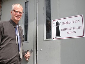 Pastor George Esser is shown in this file photo opening the door of the Harbour Inn, a homeless shelter in the River City Vineyard in Sarnia. Esser and members of his family have been gathering pledges for their upcoming climb of Mount Kilimanjaro as a fundraiser for the shelter and its legal fight. The city turned down a rezoning that would have allowed the shelter to continue operating but the church has refused to close it down. DANIEL PUNCH/ THE OBSERVER/ QMI AGENCY