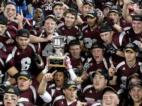 Members of the Frontenac Falcons celebrate their National Capital Bowl football championship after a 37-30 win over Barrie’s St. Joan of Arc Knights at the Rogers Centre in Toronto on Nov. 27. (Ian MacAlpine/The Whig-Standard)