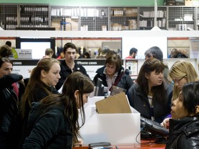 In this file photo, shoppers crowd around the cellphone desk at Future Shop to get Boxing Day sales.