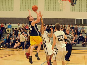 Holy Trinity alumnus Kevin MacDonald goes up for a basket Friday in an alumni game versus the Holy Trinity senior boys. The old guard defeated the upstarts 53-50 in a thrilling see-saw battle. (MONTE SONNENBERG Simcoe Reformer)