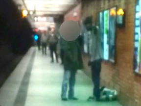 Two men are seen talking on a New York City subway platform in this framegrab from a video released by the New York City Police Department December 3, 2012.  According to police, the man on the right pushed the other man (face blocked), 58-year-old Han Ki-Suck, onto the track as the southbound train was pulling into the station. A similar fatality occurred in New York on Thursday, Dec. 27, 2012. REUTERS/NYPD/Handout