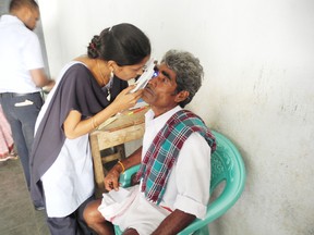 A nurse checks a man's eyes at a cataract field camp in the village of Rowthulapudi on Nov. 25.