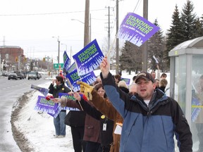 Members and supporters of the Public Service Alliance of Canada, UTE Local 42, participate in a National Day of Action rally near the Taxation Centre in Sudbury on March 1, 2012. The union was concerned the federal government planned to slash public services, resulting in massive job cuts to the federal government workforce.