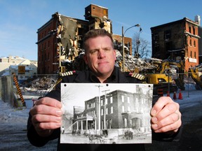 Standing outside the half-demolished Hotel Quinte, Belleville Fire Acting Chief Mark MacDonald holds a photograph of the structure taken in 1907 after its last major fire. “It didn't open again until 1912,” he said. MacDonald said the investigation into the Dec. 21, 2012 fire will take several more days to complete.