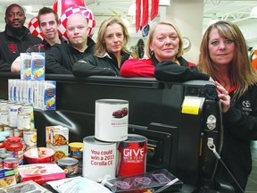 The staff of Toyota City in Wetaskiwin pose with a truck half-full of donations Dec. 18, 2012. The staff are hoping to fill the truck bed, all 36 cubed feet, with donations for the local food bank. SARAH O. SWENSON/WETASKIWIN TIMES/QMI AGENCY