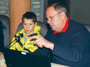 Councillor Ivan Davies  works with mock councillor Patrick Belanger on Dec. 18. Students of the Manachaban Middle School learned first hand about the inner workings of the town’s municipal government.