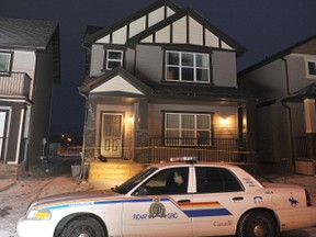 Police sit outside Andrea Conroy's house in Airdrie, Alberta. 
JAMES EMERY/AIRDRIE ECHO