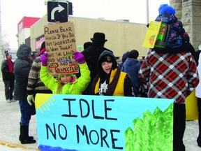 Protesters hoist signs on Saskatchewan Ave. at Royal Rd. during an Idle No More demonstration, Friday afternoon. Many groups gathered at City Hall to speak out against federal omnibus Bill C-45. (ROBIN DUDGEON/PORTAGE DAILY GRAPHIC/QMI AGENCY)