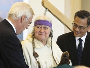Native leader and educator Laurel Claus-Johnson accepts a Queen's Diamond Jubilee Medal from Kingston and the Islands MPP John Gerretsen, left, and MP Ted Hsu earlier this year. Claus-Johnson describes the ongoing Idle No More campaign as an "awakening."