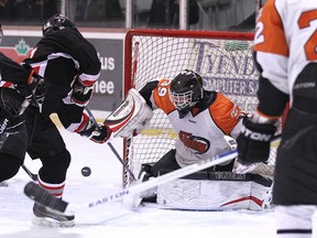 Ben Elliot makes a save on Napanee Raiders' Donny Emmons during the final seconds of the third period Friday night, in Deseronto.