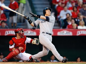 New York Yankees' Hideki Matsui pops out in front of Los Angeles Angels of Anaheim catcher Jeff Mathis during the second inning in Game 4 of their Major League Baseball (MLB) ALCS playoff series in Anaheim, California, in this file picture taken October 20, 2009. (Reuters/DANNY MOLOSHOK/Files)