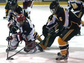 Legion 87 Dalton Bruce and New Liskeard Cub Dustin Gauvreau battle for the puck during Friday night GNML action in New Liskeard. The Cubs won the game 7-3