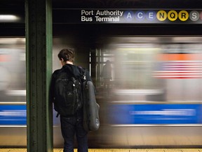 A man waits for the subway at the Times Square stop in New York, December 19, 2012. (REUTERS/Andrew Burton)