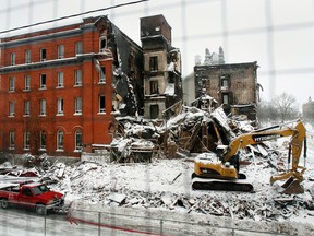 The latest snow precipitation has made demolition and Belleville's fire crews' lives more difficult at the Hotel Quinte fire scene, due to icing issues, Saturday, Dec. 29, 2012. JEROME LESSARD/The Intelligencer/QMI Agency