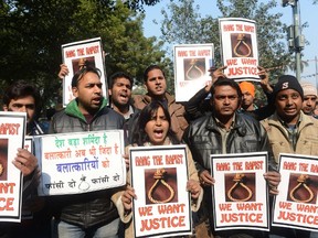 Indian protesters hold placards as they shout slogans during a protest demanding better security for women in New Delhi on December 29, 2012, as Indian leaders appealled for calm fearing fresh outbursts of protests after the death of a gang-rape student victim. (RAVEENDRAN/AFP)
