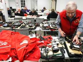 Long-time volunteer and escort driver with Operation Red Nose Quinte Peter Clark makes sure every team of volunteers has a radio and necessary maps ready to hit the road a second-last time before New Year's Eve, in Belleville, Ont. Saturday, Dec, 2012.  JEROME LESSARD/The Intelligencer/QMI Agency