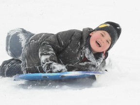 Leo Reddecopp, 6, of Delhi, took his sled for a ride down a hill near the Delhi Community Arena on Saturday, Dec. 29, 2012. Norfolk County was hit by a massive snowfall on Boxing Day and continues to see flurries fall. SARAH DOKTOR Delhi News-Record/QMI Agency