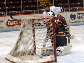 Woodstock Navy Vets forward Matt Jauernig glances to see that he's beat New Hamburg Firebirds goalie Graeme Lauerson through his legs in the third period of Saturday's game at Southwood Arena. The Navy Vets continued their 10-game losing streak losing their final game of 2012 14-2.