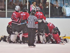 BRIAN THOMPSON, The Expositor

Aaron Jackson (left) of the Brantford 99ers sits on the ice while members of the Owen Sound Crescents Jr. Attack celebrate their 3-2 win in overtime in the midget A championship Sunday at the 43rd annual Wayne Gretzky International Hockey Tournament.