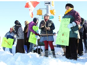 Demonstrators stand at the intersection of Princess and Concession streets Sunday to participate in an Idle No More movement in support of Attawapiskat Chief Theresa Spence, who is staging a hunger strike in hopes of persuading Prime Minister Stephen Harper to meet with her and other Aboriginal leaders. (Danielle VandenBrink The Whig-Standard)