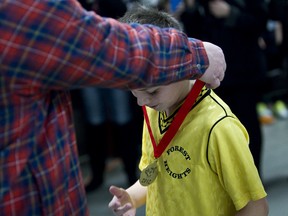 A young soccer player is awarded a medal during the Polar Cup on Dec. 30, 2012.