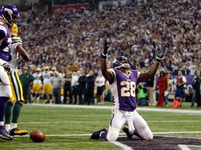Minnesota Vikings running back Adrian Peterson (28) celebrates after he runs for a  seven-yard touchdown during a carry in the first half of their NFL football game against the Green Bay Packers in Minneapolis December 30, 2012. Peterson rushed for 199 yards and scored two touchdowns. REUTERS/Eric Miller