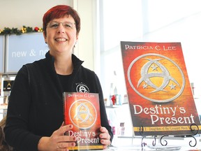 Patricia C. Lee proudly displays the second chapter of her Daughters of the Crescent Moon trilogy, Destiny’s Present, at her book launch on Saturday, Dec. 22 at Shoppers Drug Mart in Elliot Lake.
Photo by JORDAN ALLARD/THE STANDARD/QMI AGENCY
