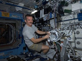 Chris Hadfield wires a condensate transfer pump aboard the International Space Station. The Sarnia-born astronaut will be commander for part of his five-month stay. SUBMITTED