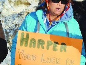 Ramona Washburn lets her sign do all the talking during the Idle No More peaceful demonstration held Dec. 29, 2012, in Hobbema, 15 kilometres south of Wetaskiwin. Dozens of walkers carried placards in support of native rights and Attawapiskat Chief Theresa Spence, who is now in her third week of a hunger strike in an effort to meet with Prime Minister Stephen Harper. JEROLD LEBLANC PHOTO/WETASKIWIN TIMES/QMI AGENCY