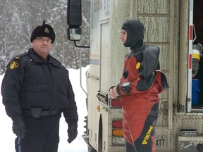 Peterborough OPP spokesman Iain McEwan, left, speaks with a member of the OPP Underwater Search and Recovery Unit as police recovered the body of a 27-year-old Owen Sound woman from Eels Lake Monday afternoon. Dana Sue Cranwell was drowned after the Jeep she was riding in broke through the water at about 12:15 a.m. Her brother, 29-year-old Patrick Cranwell, was the driver of the Jeep and was convicted of impaired driving causing death this month. The Crown is seeking a six-year sentence. 
GALEN EAGLE/Examiner/QMI Agency