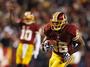 Redskins running back Alfred Morris runs untouched on a 32-yard touchdown against the  Cowboys in the second half in Landover, Md., on Sunday night. Morris scampered for 200 yards en route to a new franchise mark of 1,613 for the campaign, eclipsing the previous record held by Clinton Portis. (REUTERS)