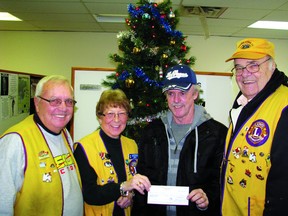 Gordon Lund (second from right) won $28,000 in lieu of a 2013 Ford Escape in the Kenora Lake of the Woods Lions Club Christmas Car Draw. From left, chairman of the draw Don Brown, president Joan Brinkhurst and Al Bollenbach. 
JON THOMPSON/Miner and News