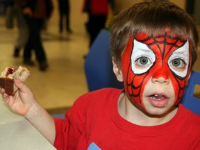 Three-year-old Jacob Shambrinho takes a break from crime fighting and festivities at the Craze to refuel with a classic peanut butter and jam sandwich before hitting the streets of MacDonald Island Park to put his spidey senses to the test. AMANDA RICHARDSON/TODAY STAFF