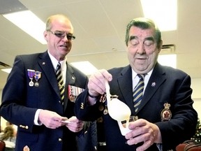 Richard Rhindress, co-chairman of the Sergeant-at-Arms with the Royal Canadian Legion in Callander, and past-president Larrie Coulson salute the new year with rum-soaked moose milk during the New Year's Day levee. (MARIA CALABRESE The Nugget)