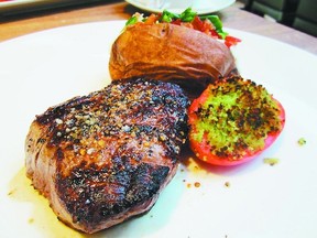 A lunch-time Chop top sirloin, baked potato and tomato gratin. (SUPPLIED)