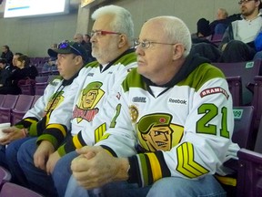 Longtime Brampton Battalion fans Jason Walker, left, Rob McLean and Jim Walker take in the action during Monday's home game at the Powerade Centre in Brampton, a 5-2 win over the Mississauga Steelheads.