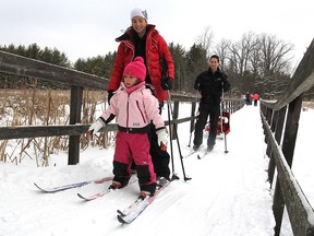 Cross-country skiers Gareth Davies and wife Esley Albert come back from the trails at the Little Cataraqui Creek Conservation Area on outer Division Street on Monday morning with their children Evelyn, 4, and Colden, 2. (Michael Lea The Whig-Standard)