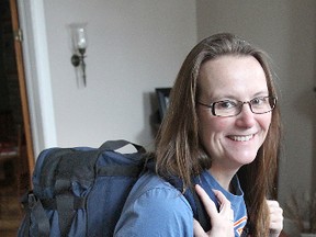 Bayridge Secondary School teacher Brenda Scarlett wears the backpack she will be taking on a 20-day trip to India with some of her students. (Michael Lea The Whig-Standard)