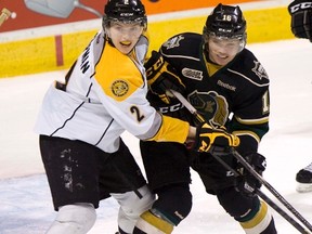 London Knights forward Max Domi (right) tangles with Sarnia Sting defenceman Joshua Chapman at Budweiser Gardens in London, Ont., Jan. 1, 2013. (DEREK RUTTAN/QMI Agency)