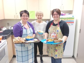 Trays of food heading to classrooms are prepared at schools throughout Bruce and Grey counties each day, by volunteers such as Cindy Dietz, left and Marie Bezeau, left. They were joined recently at Hanover Heights by Grey Bruce Eat and Learn co-ordinator Bev Gateman.