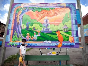 Joe Bartolo, 5, stands in front of a mural he and a group of other children helped Lonsdale artist Maureen Walton create. The mural was installed in downtown Deseronto last week.
